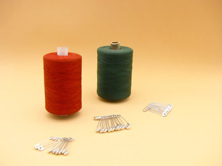 sewing kit. two spools of thread and safety pins