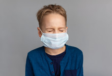 Caucasian Sick Boy Wearing A Protective Mask. Contagious Virus Concept. Coronovirus Concept.