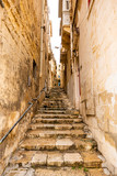 Fototapeta Na drzwi - stairs in narrow street in Malta