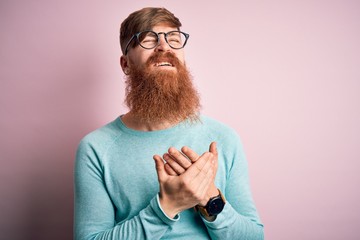 Poster - Handsome Irish redhead man with beard wearing glasses over pink isolated background Suffering pain on hands and fingers, arthritis inflammation