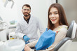 © Ihor - Young beautiful woman smiling to the camera sitting in dental chair at dentists office