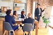 © Krakenimages.com - Group of business workers smiling happy and confident in a meeting. Working together looking at presentation using board and charts at the office.