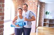 Middle age beautiful sporty couple doing yoga at gym