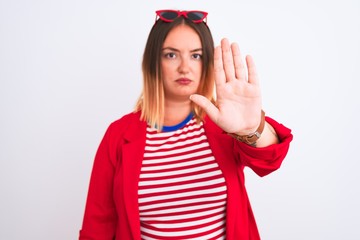 Sticker - Young beautiful woman wearing striped t-shirt and jacket over isolated white background doing stop sing with palm of the hand. Warning expression with negative and serious gesture on the face.