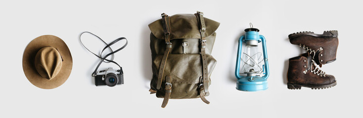 Wall Mural - minimalist style composition of hat, backpack and boots on white background isolated