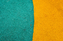Green And Yellow Bright Soft Rubber Flooring Safe For Sports And Workout Or On The Playground From The Many Small Round Pebbles Pressed. Background, Texture