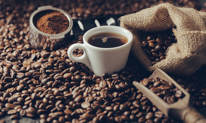 Poster - Ground coffee and coffee beans on old cafe table.