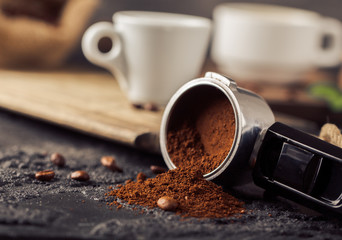 Wall Mural - Ground coffee and coffee beans on old cafe table.