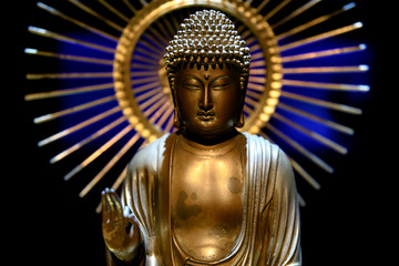 Buddha golden statue inside a dark temple