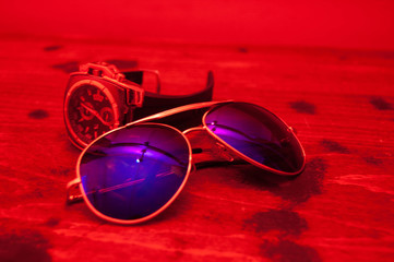 Male world: stylish men's glasses and watches on a wooden background