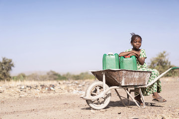 Cute Native African Women Carrying healthful Water in a village