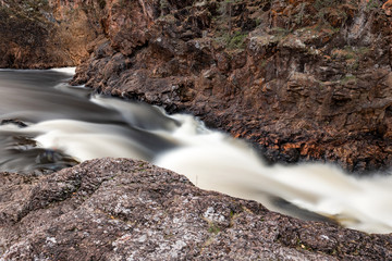 Wall Mural - Long exposure of rapid mountain river flowing through the rocks