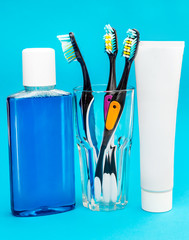 Different tools for oral hygiene on blue.