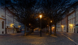 Fototapeta Paryż - A quiet old cobbled square in Prague during the early morning