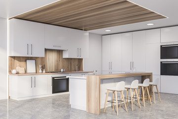 Corner of wooden kitchen with countertops and bar