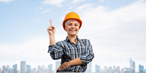 Beautiful female builder in hardhat