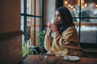 Young woman drinking tea sitting in cafe