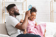 © Prostock-studio - Loving black father brushing his cute daughter hair