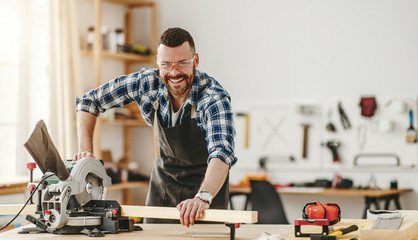 young male carpenter working in  workshop.