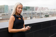 © kjekol - Athletic Woman with Headphones and Smartwatch Rests After Workout In City