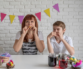 Happy mother and boy blowing up the balloons