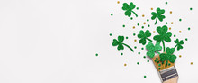Creative St. Patricks Day Concept Made With Paint Brush And Green Glitter Shamrocks And Confetti. Banner Format