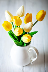 Wall Mural - bouquet of spring tulips on a bright background. greeting card. space for text.