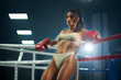 © serhiibobyk - Female fighter in underwear posing near ring.