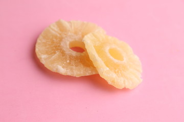 piece of dried pineapple fruit in color background