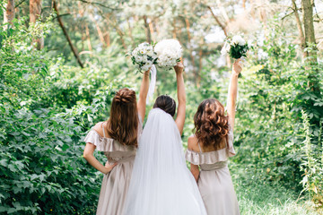 Bride and bridesmaids holding beautiful bouquetes