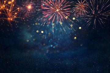 Wall Mural - abstract gold, black and blue glitter background with fireworks. christmas eve, 4th of july holiday concept