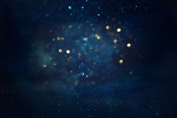 Wall Mural - abstract glitter black, gold and blue lights background. de-focused