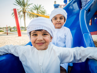 Wall Mural - Arabic kids playing at the park in Dubai