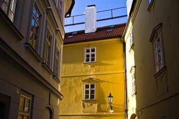 A yellow window with two windows and a street lantern (Prague, Czech Republic, Europe)