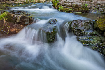 Water streaming over rocks, slow shutter speed