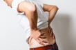 © Angelov - Lumbago symptom. Young man holding his painful inflamed loin. Health care and medicine.