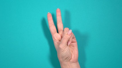 Wall Mural - Closeup view of female manicured hand counting from zero to five using fingers. 