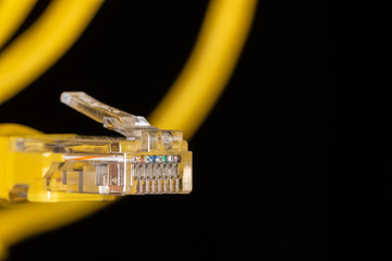 Yellow data cable connector on black background