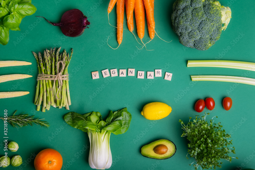 Top view set of healthy raw vegetables on the green background with ...