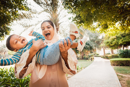 Arabic mom and her little toddler playing outdoors