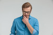© Viorel Sima - thoughtful casual man holding hand to chin and thinking