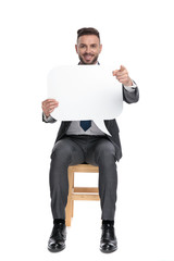 Wall Mural - happy young businessman holding speech bubble