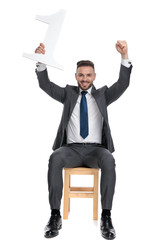 Canvas Print - happy young businessman holding number one sign