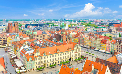 Top aerial panoramic view of Wroclaw old town historical city centre with Rynek Market Square, Old Town Hall, New City Hall, colorful buildings with multicolored facade and tiled roofs, Poland