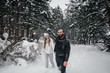 © Andrii - Couple playing with snow in the forest