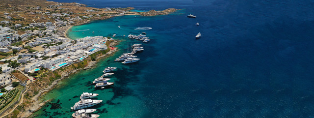 Aerial drone ultra wide photo of famous celebrity beach of Psarou in island of Mykonos, Cyclades, Greece