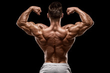 Muscular Man Showing Back Muscles Rear View, Isolated On Black Background. Strong Male Naked Torso