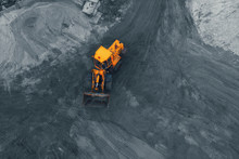 Yellow Excavator Or Bulldozer In Coal Open Cast Mining Quarry, Aerial Top View From Drone.