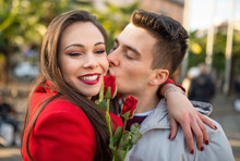 Man Giving Flowers And Kissing His Girlfriend