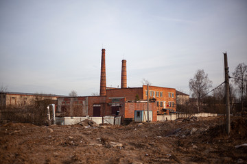 Brick factory. The old factory. Industrial landscape. Brick pipes. Industrial processing area. Environmental pollution. Entirely red building.